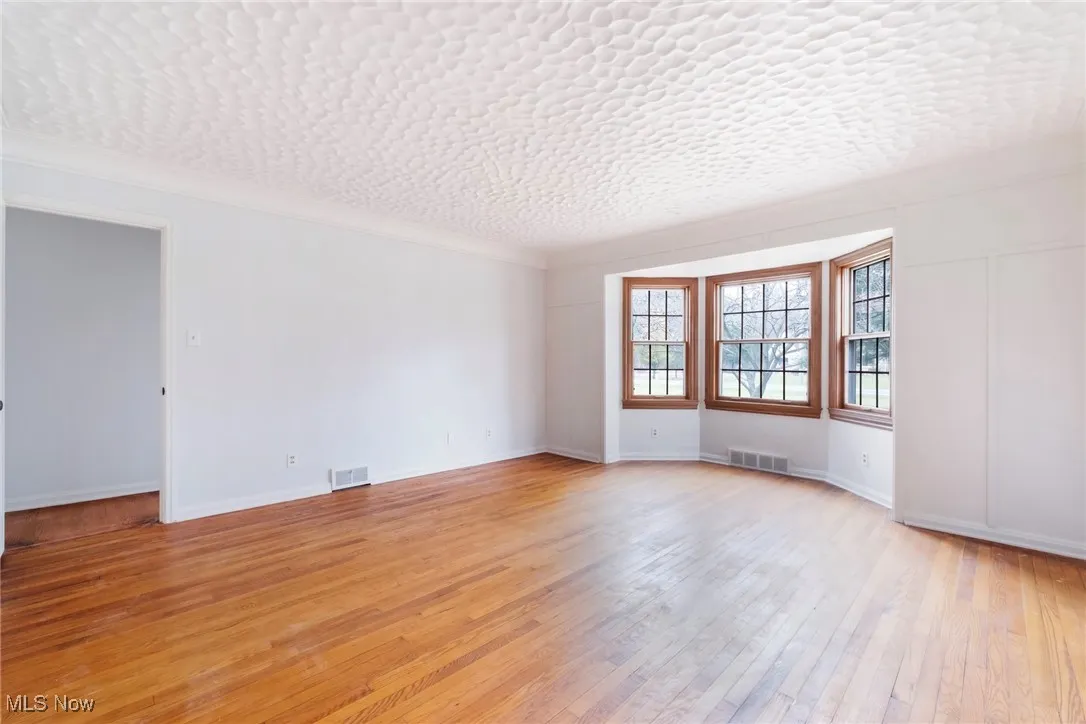Unfurnished room featuring light wood-style floors and baseboards