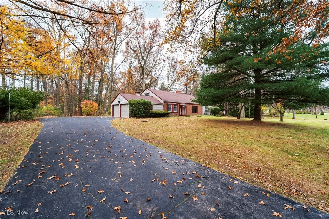 View of front of house with a chimney and a front yard
