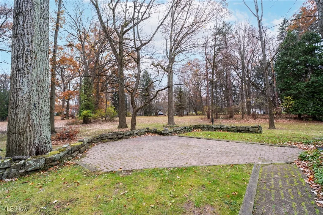 View of green lawn featuring a patio