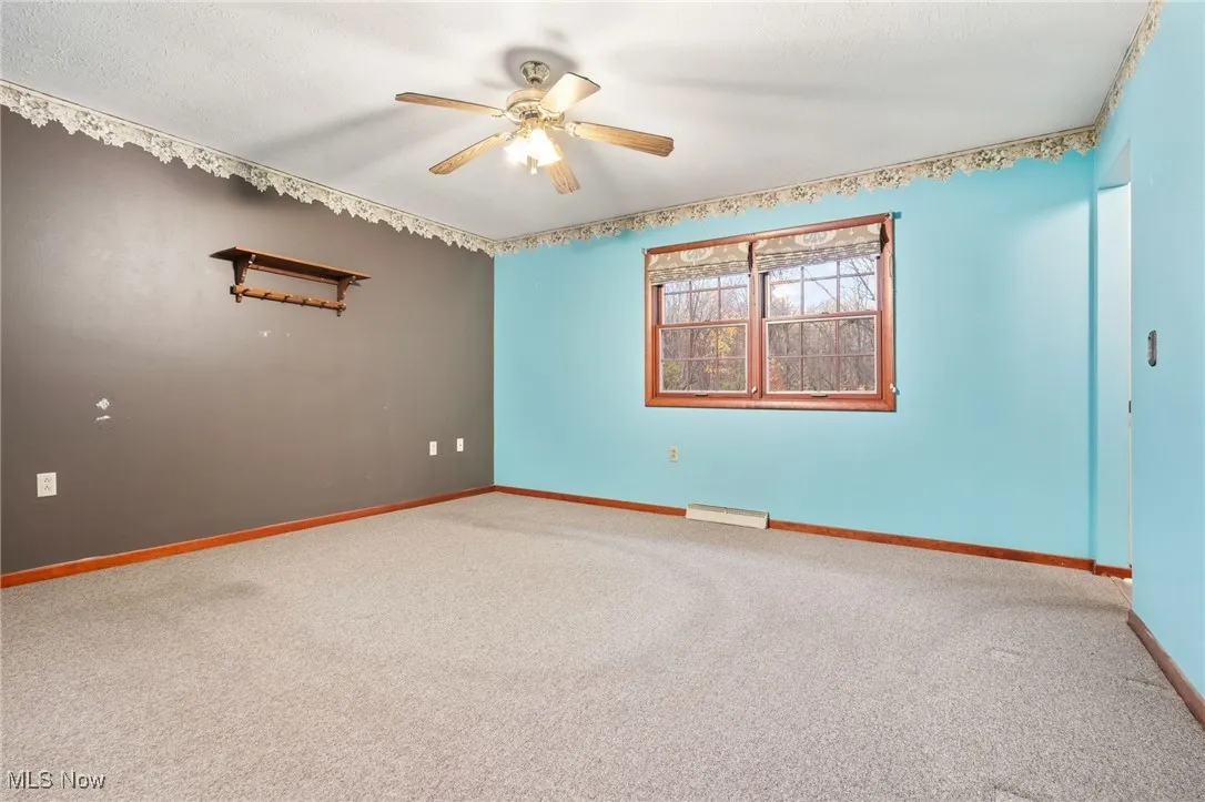 Primary Suite featuring carpet and ceiling fan