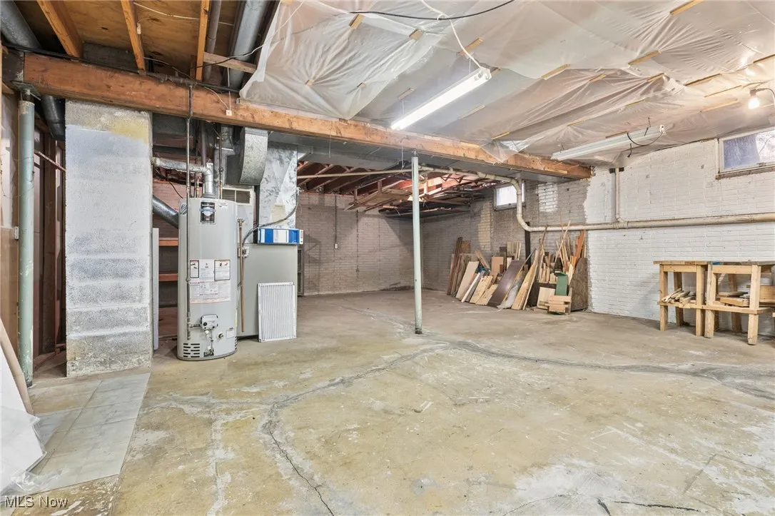 Unfinished below grade area featuring room for storage, the gas water heater, and furnace