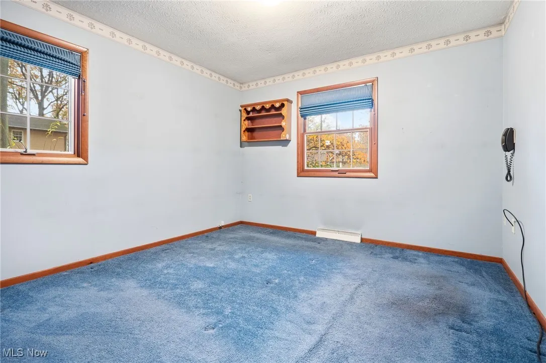 Bedroom with carpet floors, a lighted closet, and a textured ceiling