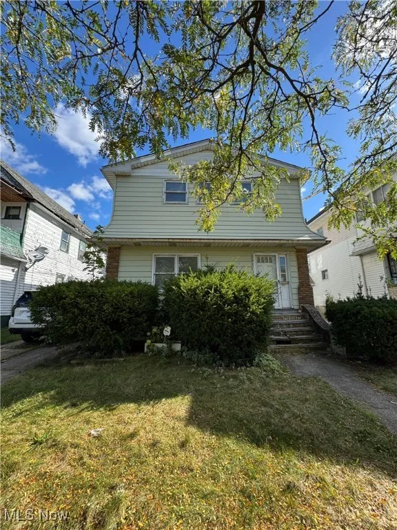 View of front of home with a front lawn and brick siding