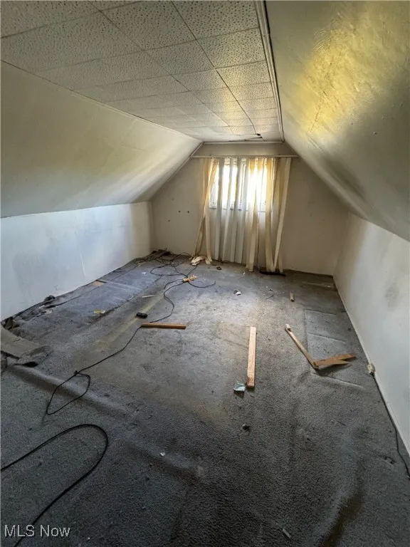 Additional living space featuring lofted ceiling