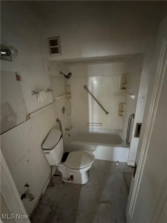Full bath featuring toilet and shower / tub combination