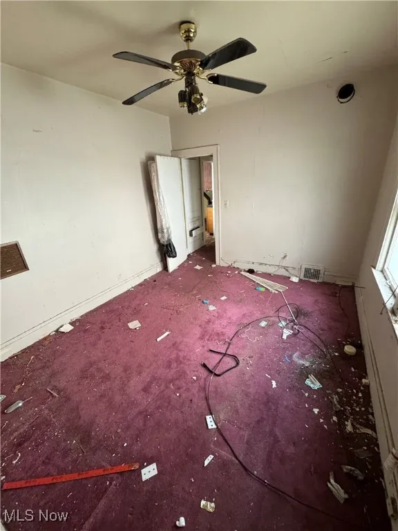 Unfurnished bedroom with carpet flooring and a ceiling fan