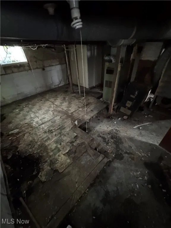 Basement featuring heating unit