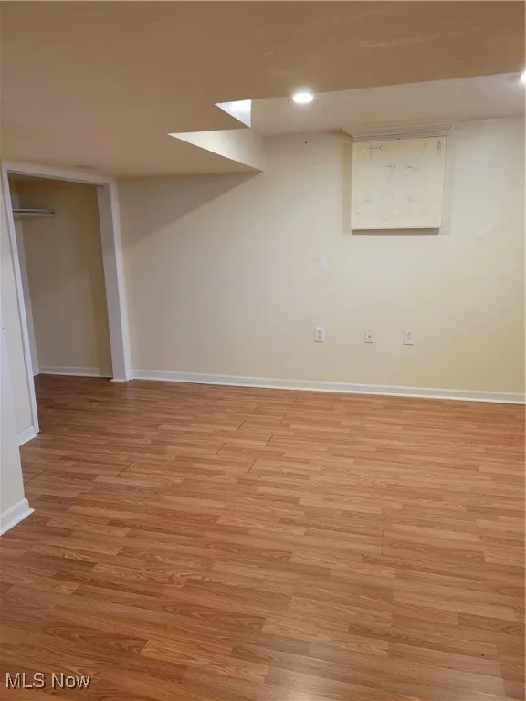 Finished basement featuring light wood finished floors and recessed lighting