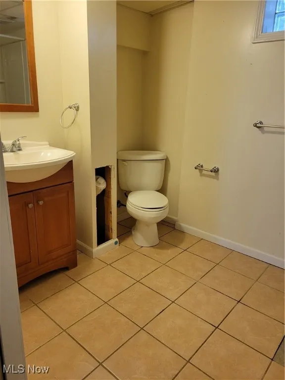 Bathroom with vanity, a shower, and light tile patterned floors