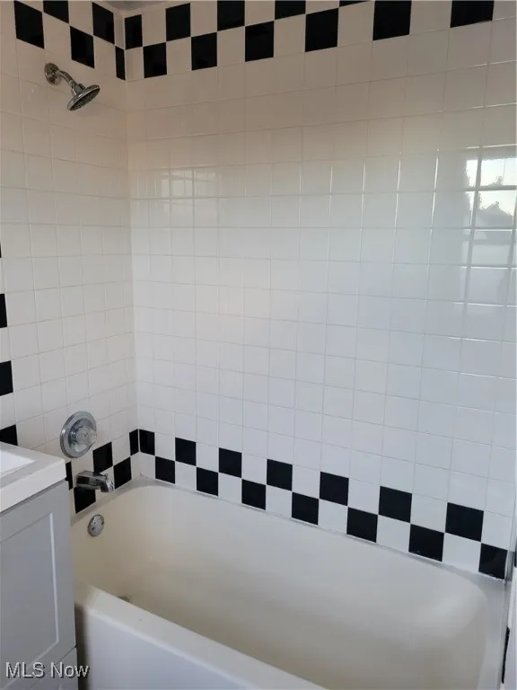 Full bath featuring vanity and shower / tub combination