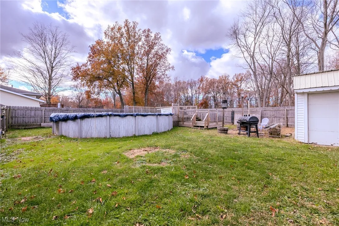 Fenced backyard with a wooden deck