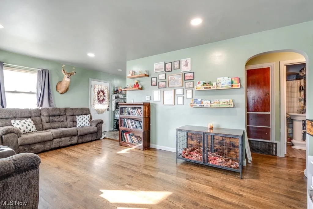 Living room with view of doorway to bedrooms as well as entrance to kitchen