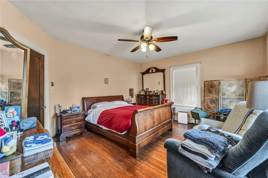 Bedroom featuring hardwood / wood-style floors and a ceiling fan