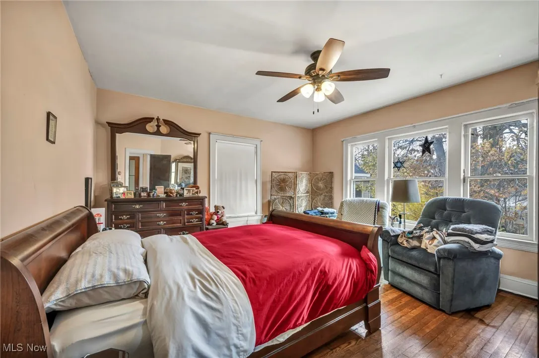 Bedroom with hardwood / wood-style floors and a ceiling fan