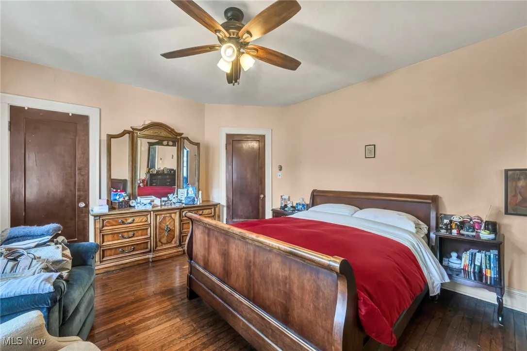 Bedroom featuring dark wood-style flooring and a ceiling fan