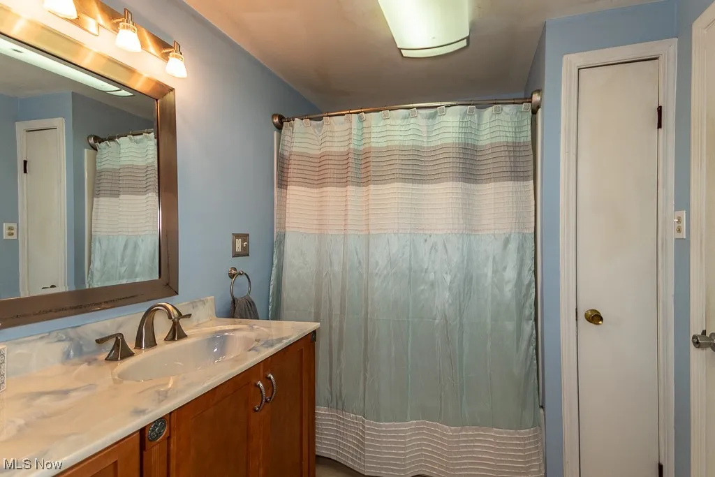 First-floor tub and shower with linen closet