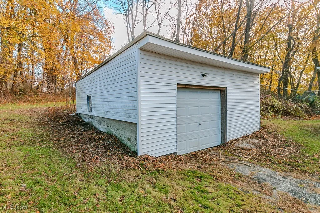 Detached garage with metal roof, electricity and newer garage door