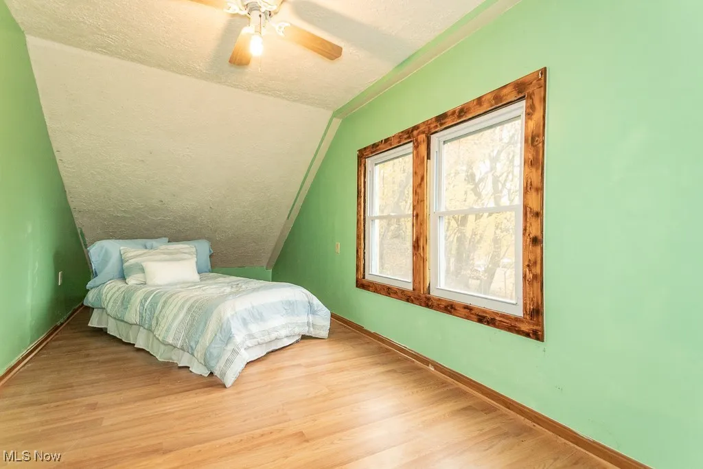 Upstairs bedroom with view of West side of the yard - unwind with a book as the sun sets!