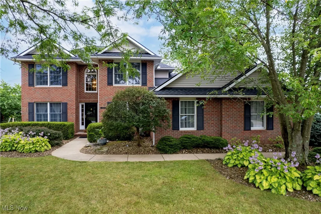 View of front of house with a front lawn and brick siding