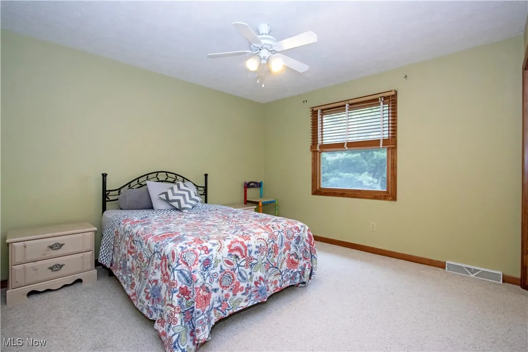 Bedroom featuring carpet floors and ceiling fan