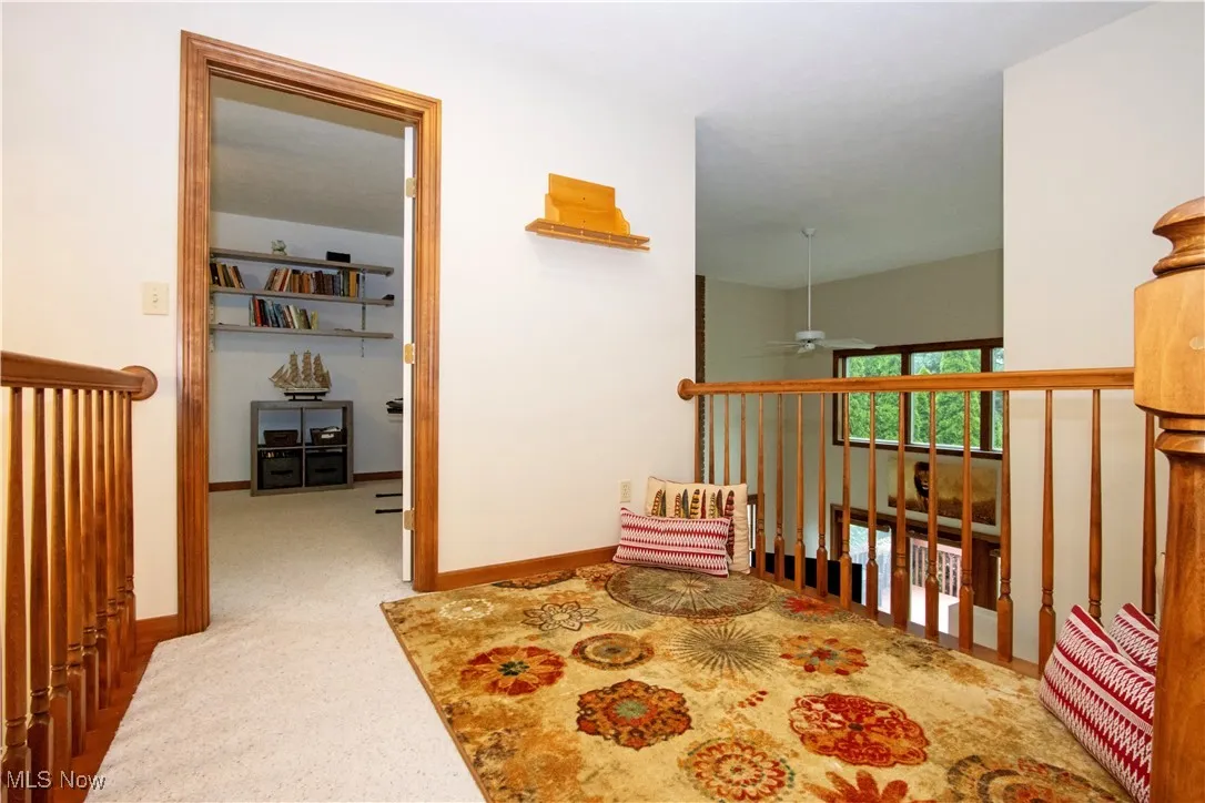 Corridor with baseboards and carpet flooring