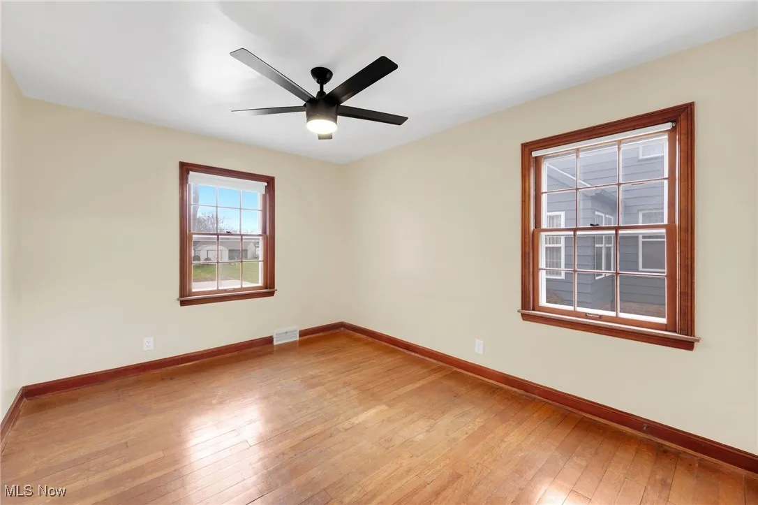 Spare room with light wood-type flooring and ceiling fan