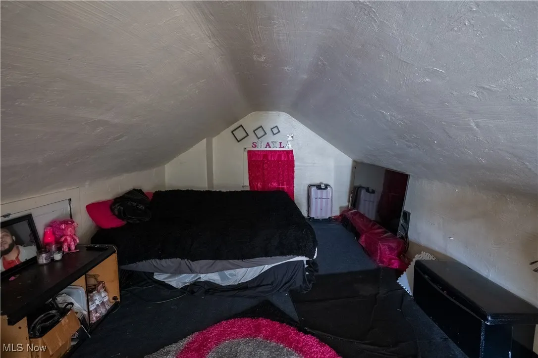 Bedroom featuring vaulted ceiling