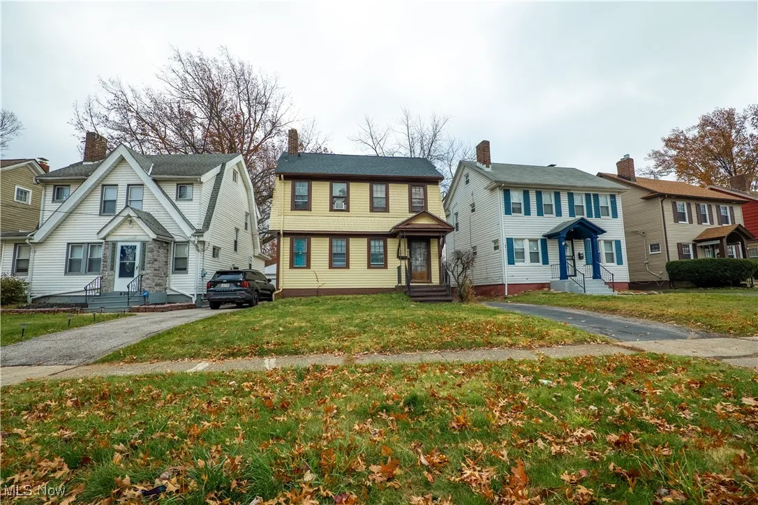 Colonial inspired home with a front yard and driveway