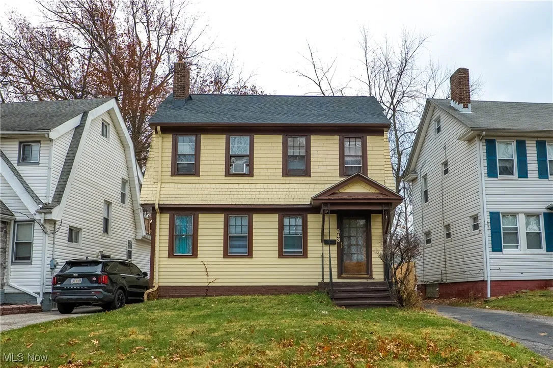 View of front of property featuring a front lawn and a chimney
