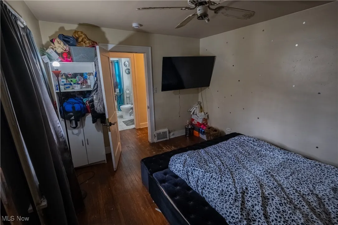 Bedroom featuring dark wood-style flooring and a ceiling fan
