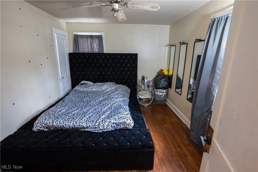 Bedroom featuring dark wood-type flooring and ceiling fan