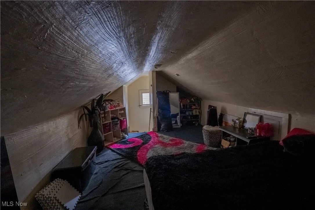 Bedroom with lofted ceiling