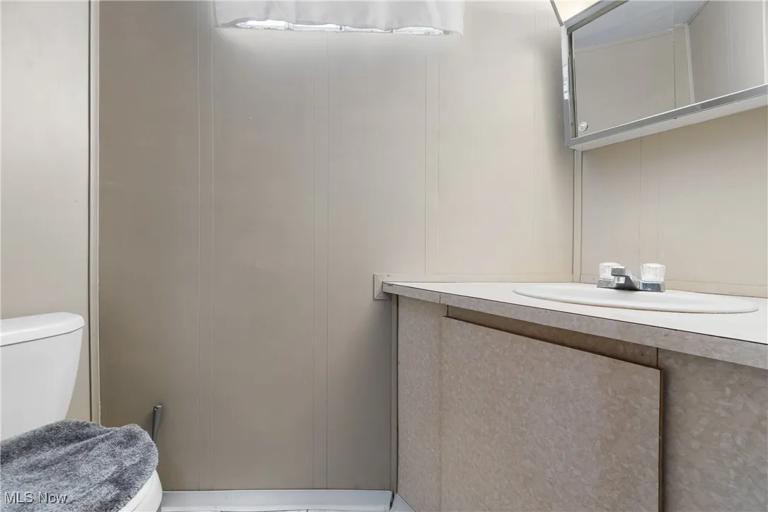 Full Bathroom with vanity and toilet