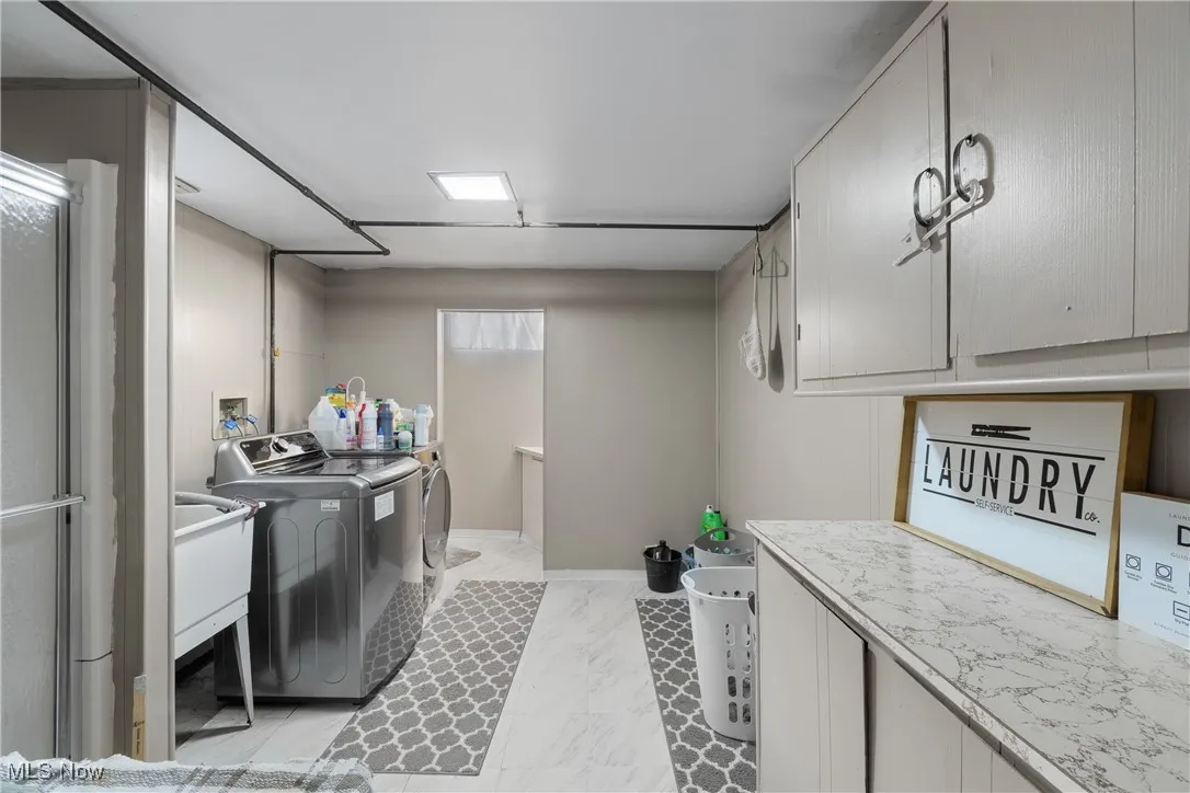 Laundry area with washing machine and dryer and cabinet space