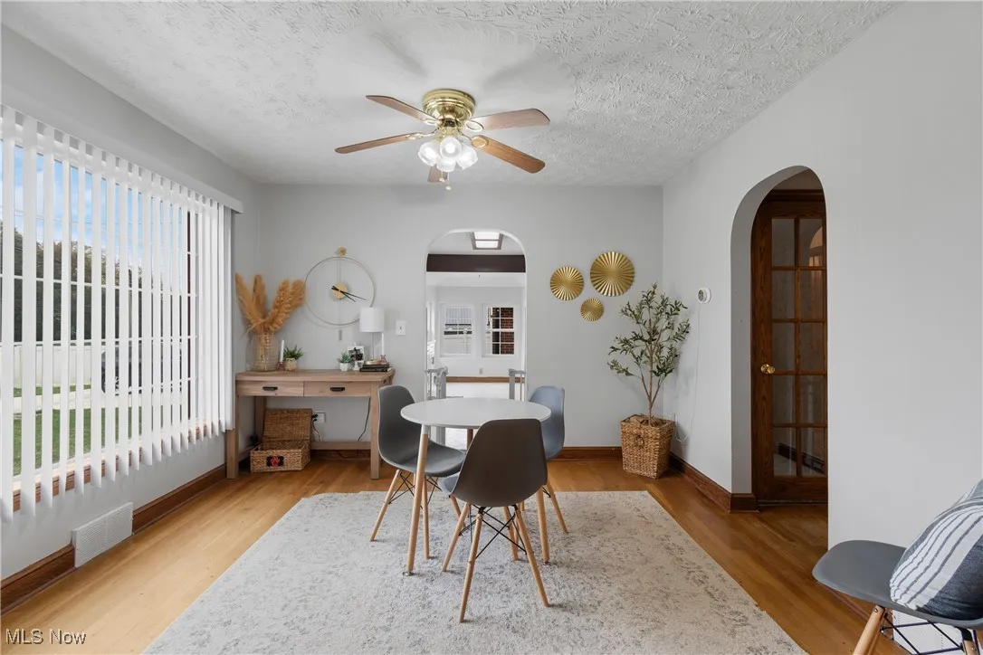 Bedroom featuring a ceiling fan, french door access to outside, and hardwood flooring