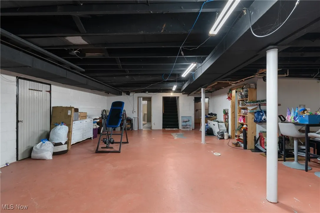 Unfinished below grade area featuring concrete block wall