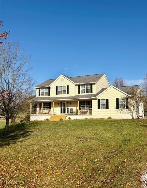 View of front facade with a porch and a front yard