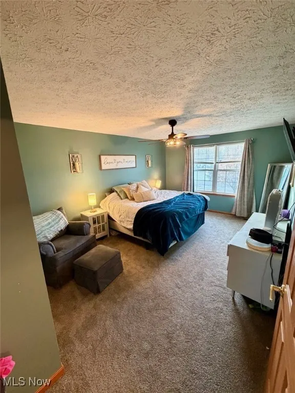 Bedroom featuring carpet and a ceiling fan