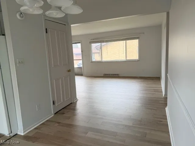 Spare room with light wood-style floors and a smoke detector
