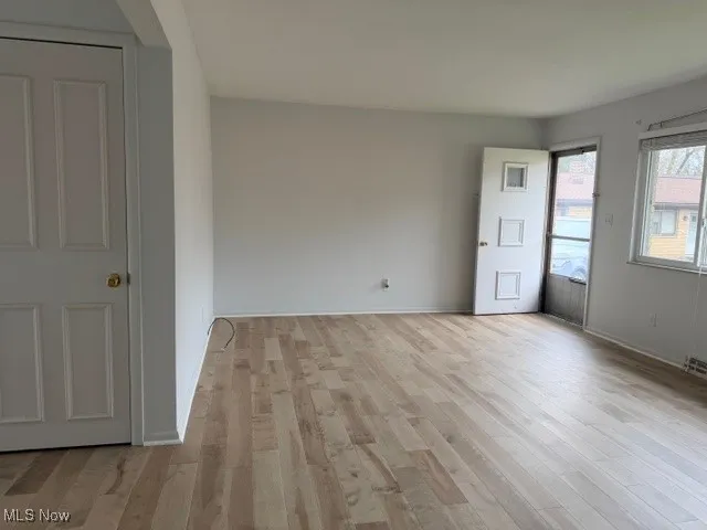 Empty room featuring light wood-style flooring and baseboards