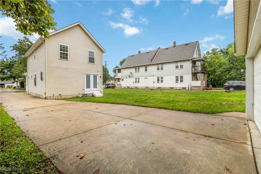 Rear view of property featuring a lawn