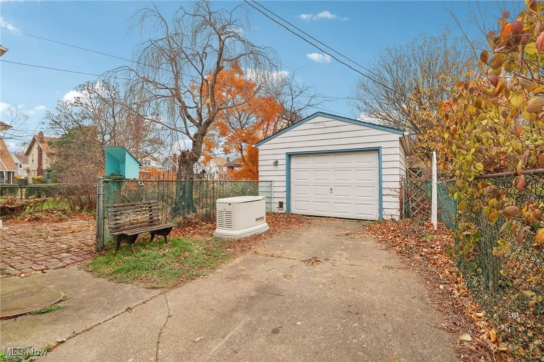 Detached garage featuring concrete driveway