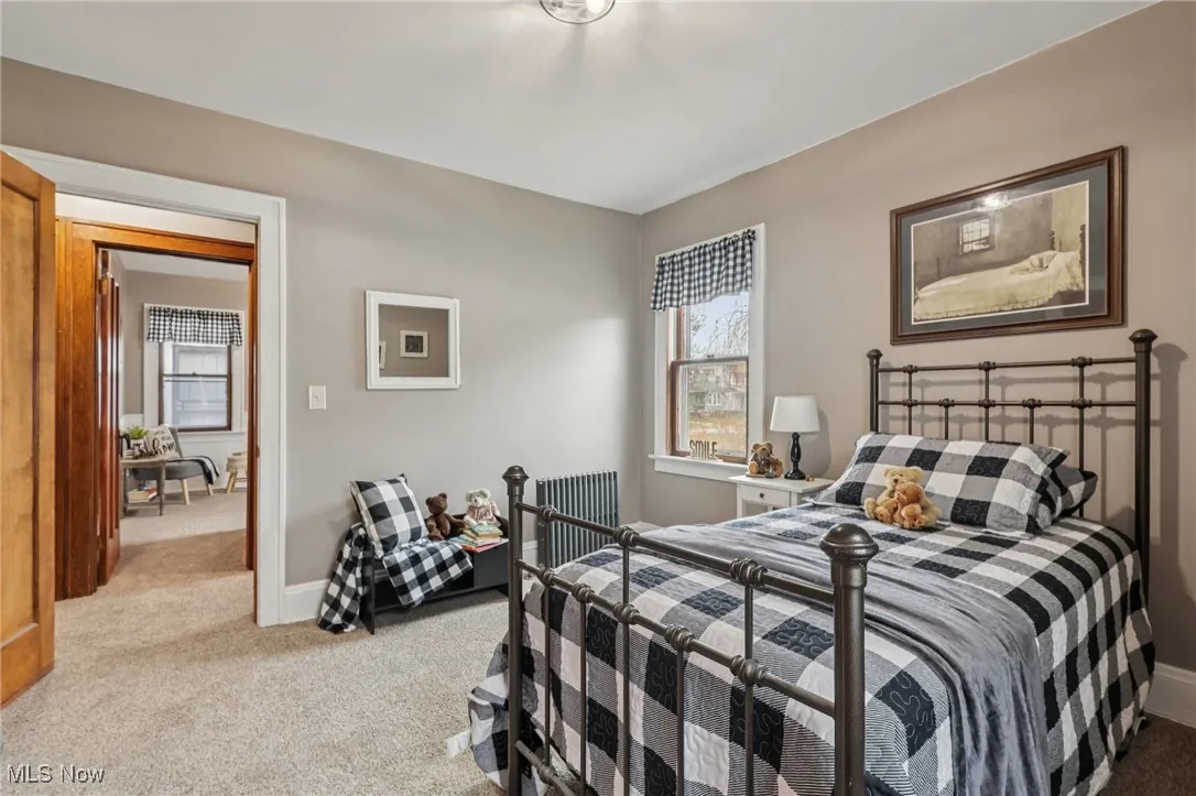 Bedroom featuring light colored carpet