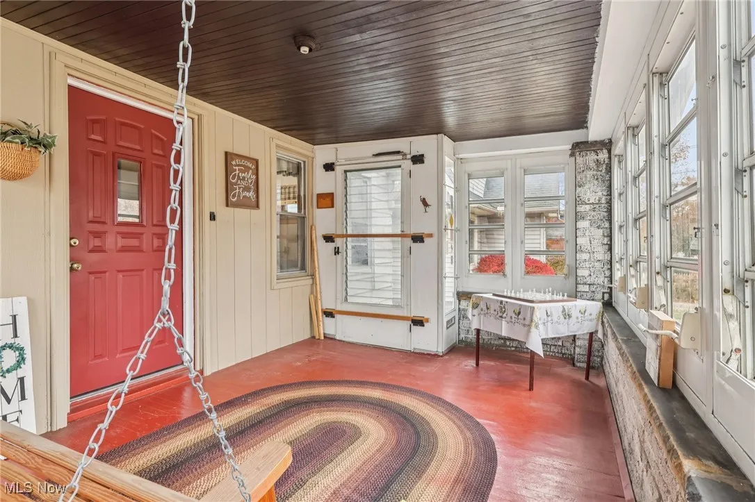 Sunroom with wood ceiling, wood walls, and wood finished floors