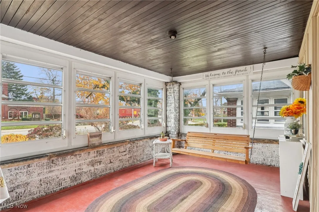 Unfurnished sunroom with wood ceiling