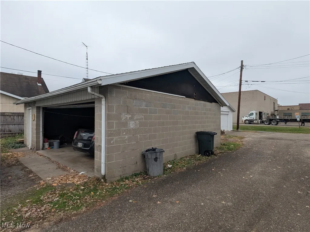 View of home's concrete block detached garage