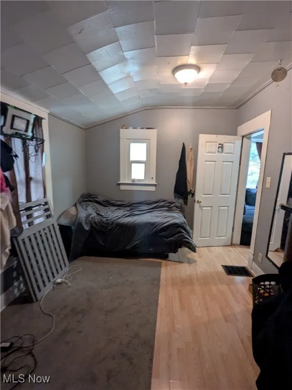 Bedroom featuring laminate wood finished floors