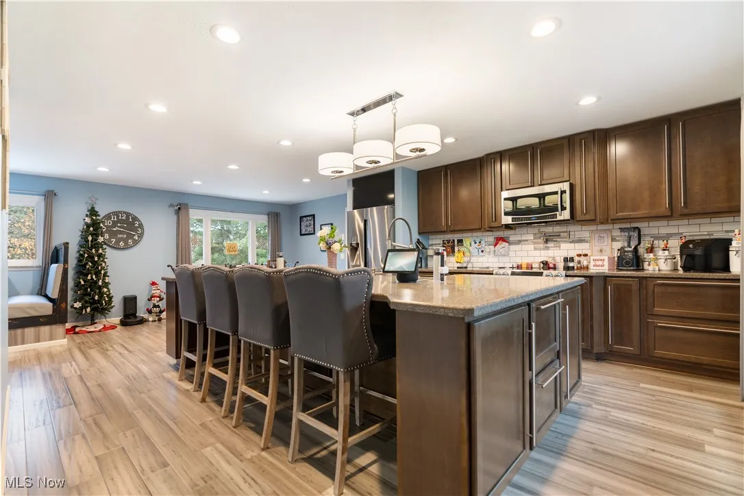 Fantastic lighter countertops, backsplash and flooring are a great combination with the dark cabinets.