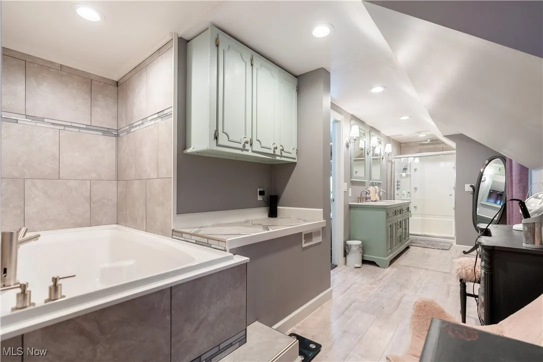 Separate walk-in shower, soaking tub and vanity spaces.