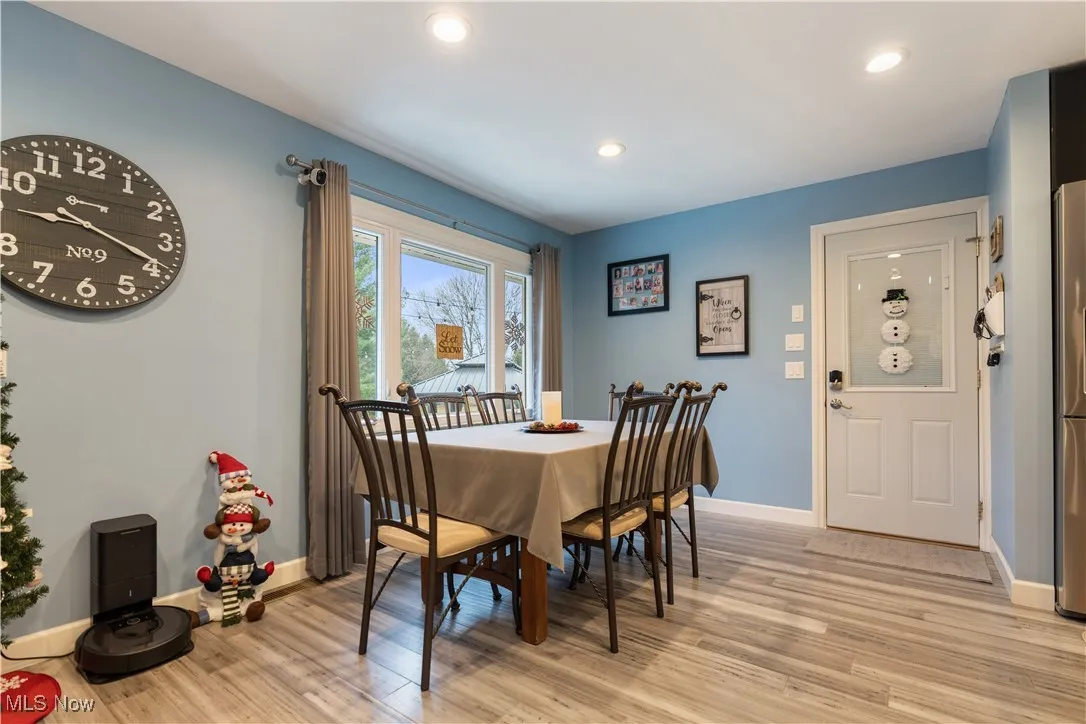 Dining area at the end of the kitchen with a window overlooking the back yard.